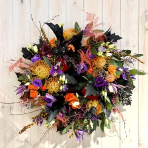 Halloween door wreath. Seasonal flowers with added scary spider detail - a great way to welcome visitor to your home this Halloween