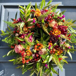 An autumn floral door wreath available to order to collect of for delivery across Dublin.